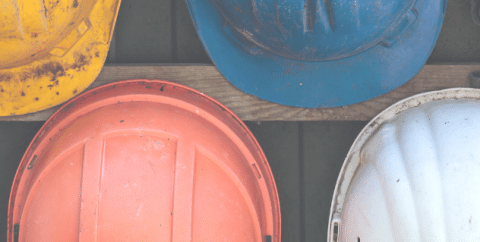 Four hard hats with different colours.